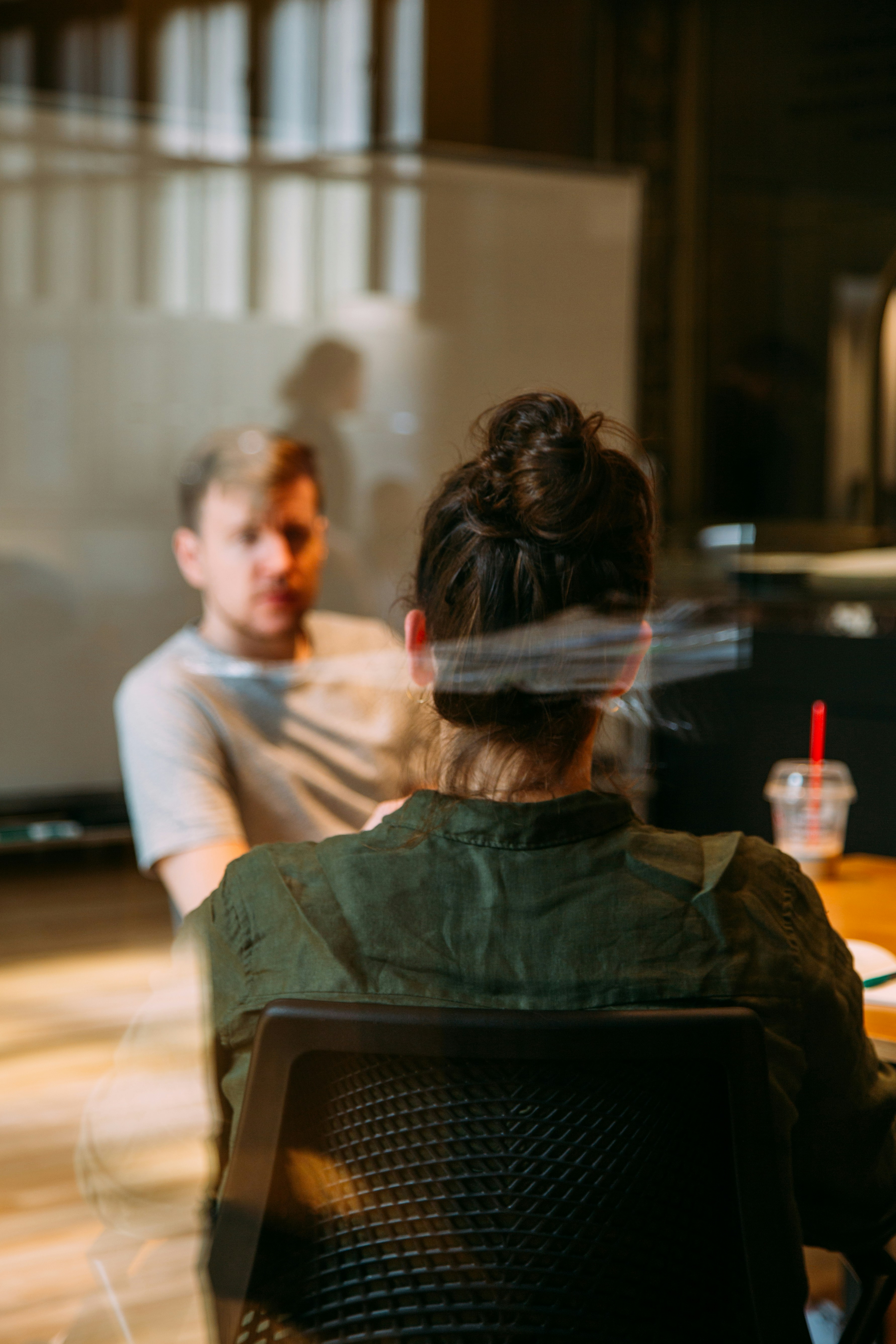 You look through a huge glass window, you can see two people having a private one on one conversation